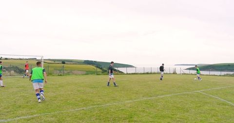 Teen soccer match on a scenic coastal field