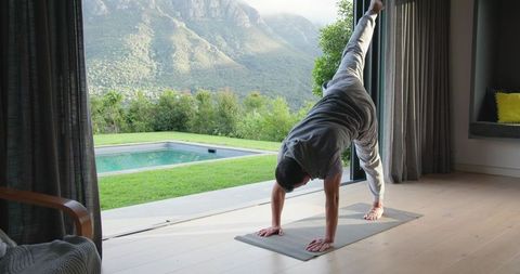 Man Practicing Yoga in SereneSetting Near Picturesque Landscape