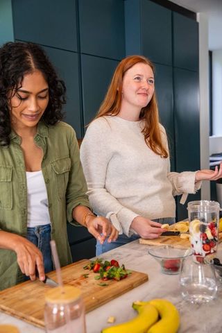 Diverse Friends Preparing Smoothies in Modern Kitchen
