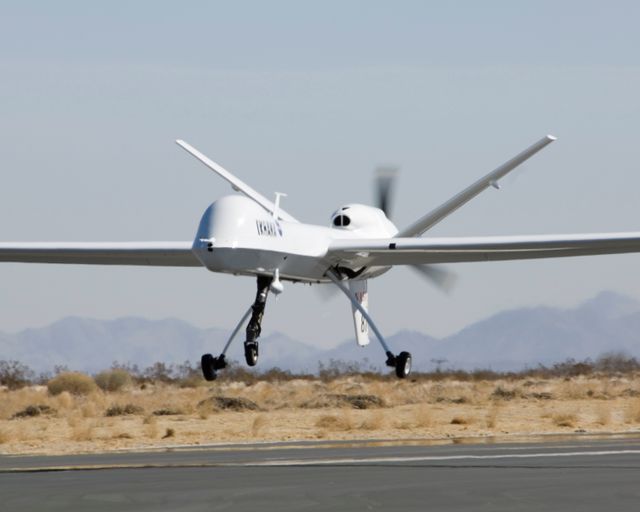 NASA's Ikhana unmanned air vehicle seen lifting off from Grey Butte airfield in Southern California. This aircraft, a civil variant of the Predator B, is used for scientific research and demonstrations. The image captures captivating aerospace technology and may be useful for educational content on aviation or scientific advancements, as well as articles and publications about unmanned aircraft systems and innovations in aerospace.