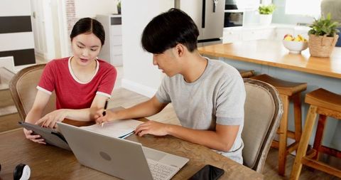 Young Adults Studying Together in Modern Kitchen