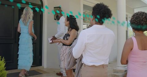 Guests waiting on porch for housewarming woman in tiered blue dress holding gift