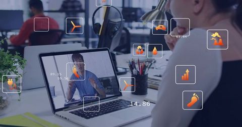 Woman viewing laptop during virtual meeting with augmented analytics in open office