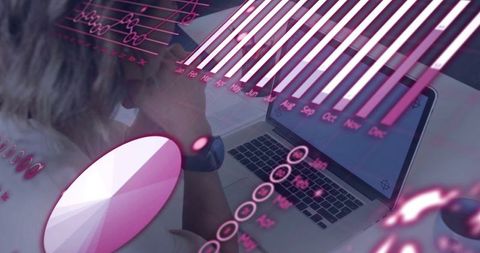 Business Analyst Reviewing Chart Overlays on Laptop in Office