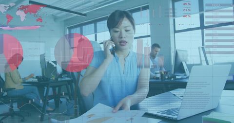 Asian Businesswoman Analyzing Financial Data on Computer