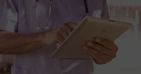 Healthcare Professional Using Tablet for Modern Diagnostics