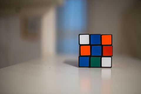 Incomplete rubik's cube on smooth white surface