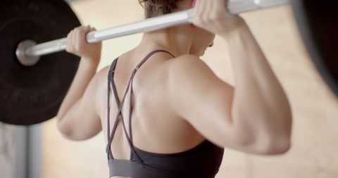 Woman Lifting Barbell in Modern Gym for Strength Training - Download Free Stock Images Pikwizard.com