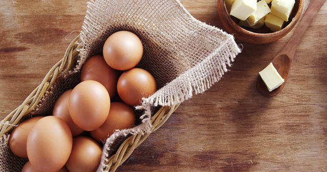 Fresh Brown Eggs in Basket and Butter on Wooden Surface - Download Free Stock Images Pikwizard.com