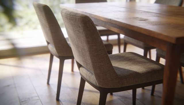 Sunlit upholstered dining chairs with rustic wooden table, cozy natural-light dining nook
