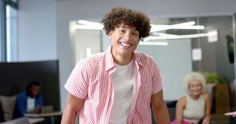 Young man smiling in modern office environment