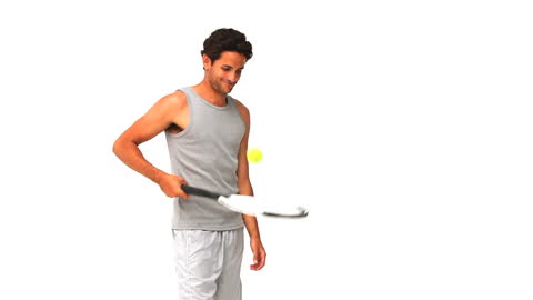 Man Practicing Tennis with Racket and Ball on White Background