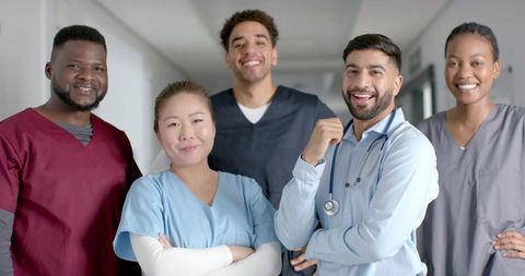 Diverse Healthcare Team in Hallway Smiling Confidently