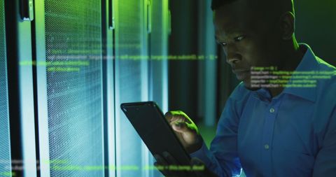Engineer Using Digital Tablet Amidst Data Processing in Server Room - Download Free Stock Images Pikwizard.com