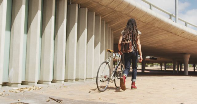 Urban Commuter with Bicycle Beneath Modern Overpass - Download Free Stock Images Pikwizard.com