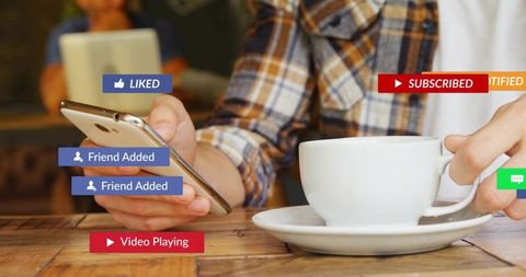 Holding smartphone and coffee cup while tapping social notifications and subscribing