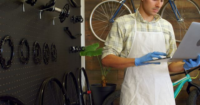 Mechanic in Bicycle Repair Workshop using Laptop - Download Free Stock Images Pikwizard.com