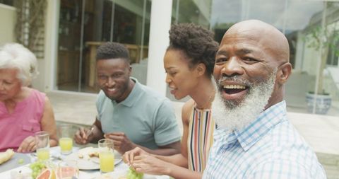 Happy Family Enjoying Breakfast Outdoors Together