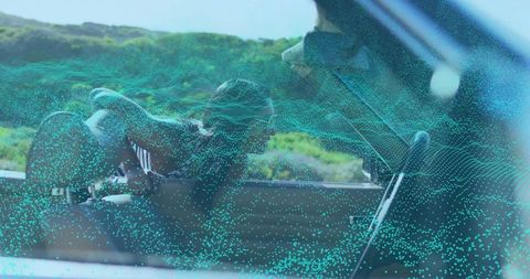 Sunglassed woman in convertible with digital overlay