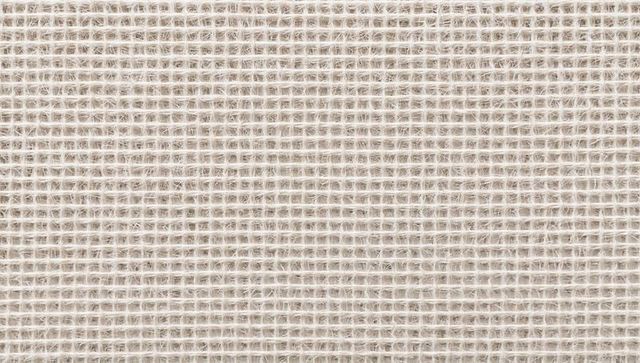 Off-white open-weave textile showing yarn fibers, square grid pattern and soft fibrils