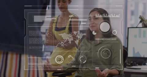 Women collaborating with futuristic hud data dashboard in modern open-plan startup office