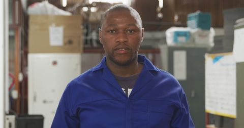 Warehouse Worker in Blue Uniform Smiling at Camera - Download Free Stock Images Pikwizard.com