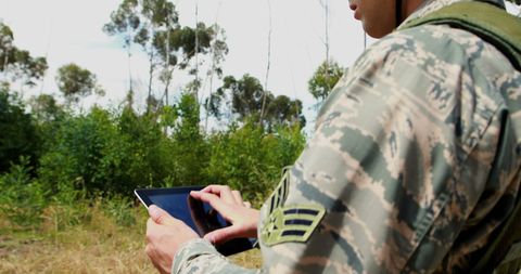 Military Personnel Using Tablet in Natural Environment - Download Free Stock Images Pikwizard.com