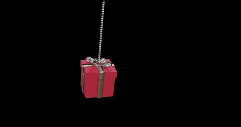 Red Christmas Present Ornament Hanging on Dark Background