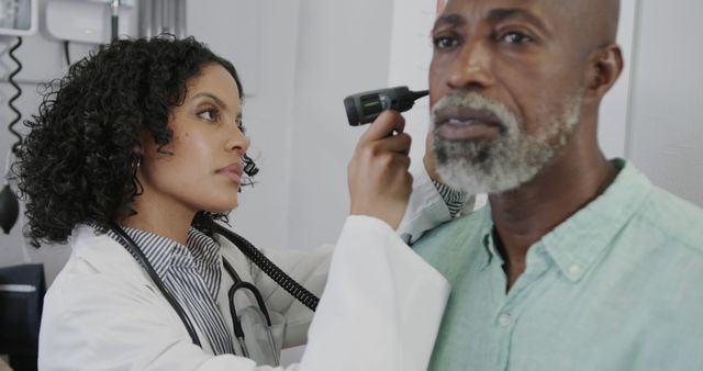 Doctor Examining Elderly Patient’s Ear with Otoscope in Clinic - Download Free Stock Images Pikwizard.com