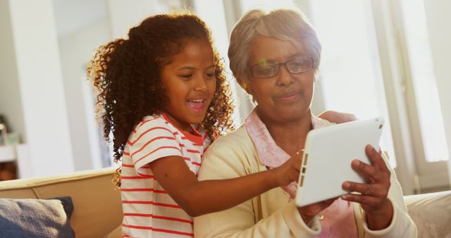 Grandmother and granddaughter using digital tablet - Download Free Stock Images Pikwizard.com