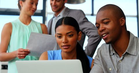 Diverse Team Collaborating on Laptop During Office Meeting - Download Free Stock Images Pikwizard.com