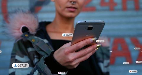 Urban streetwear woman holding smartphone with gold nails and social metrics overlay