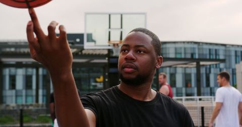 Young Athlete Spinning Basketball Outdoors for Practice
