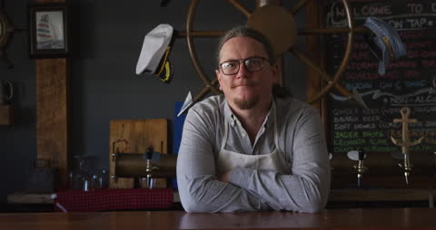Friendly Barman Smiling in Microbrewery with Chalkboard Details
