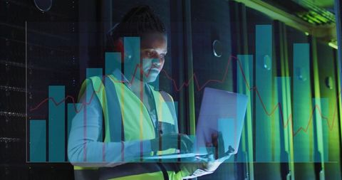 Black Data Center Technician Working on Laptop with Headset and Analytics Overlays
