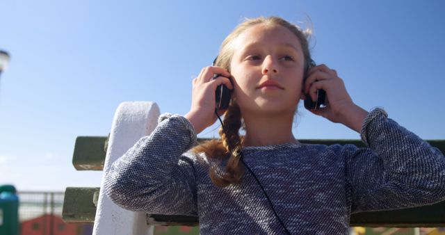 Young Girl Enjoying Music on Sunny Day Outdoors - Download Free Stock Images Pikwizard.com