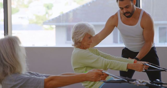 Elderly Women Receiving Fitness Training from Personal Trainer in Gym - Download Free Stock Images Pikwizard.com