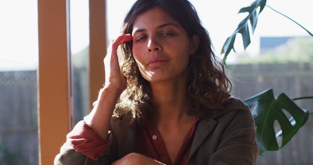 Woman Resting and Relaxing With Hand on Head Near Window - Download Free Stock Images Pikwizard.com