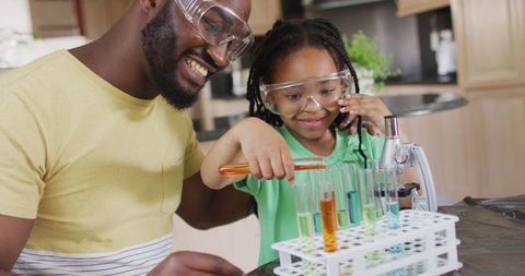 Father and Daughter Conducting Science Experiments at Home