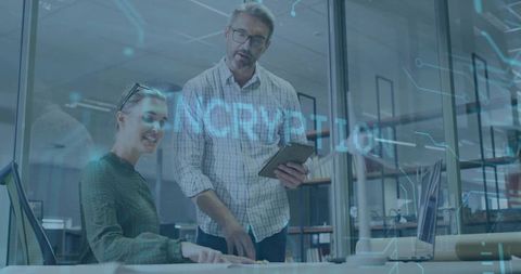 Team collaborating on cybersecurity and encryption with tablet in glass office