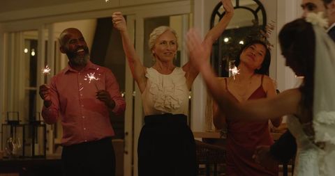 Bride and Groom Celebrate with Sparklers at Wedding Reception