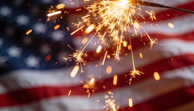 Sparklers glowing over american flag celebrating fourth of july fireworks patriotism