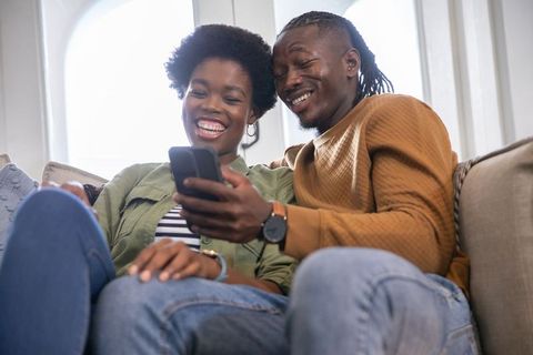 Happy Multicultural Couple Relaxing Together at Home