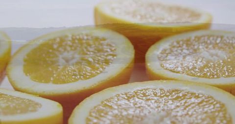 Halved oranges revealing juicy pulp in close-up studio composition for food and beverage