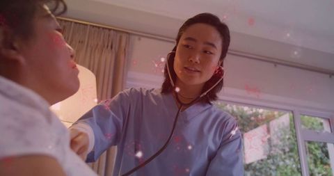 Caregiver checking health in comfortable home setting