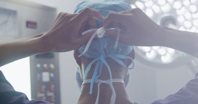 Surgeon Preparing for Operation with Surgical Cap in Operating Room - Download Free Stock Images Pikwizard.com