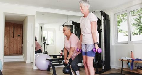 Senior Lesbian Couple Enjoying Home Exercise Routine with Weights