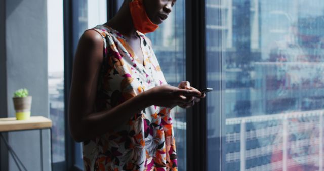 Businesswoman Typing on Smartphone near Window in Modern Office - Download Free Stock Images Pikwizard.com