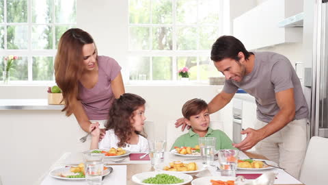 Smiling Family Enjoying Meal Together in Bright Modern Kitchen