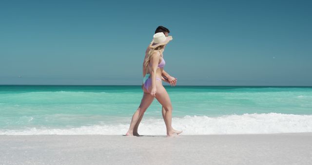 Couple Walking on Beach with Turquoise Water and Clear Sky - Download Free Stock Images Pikwizard.com